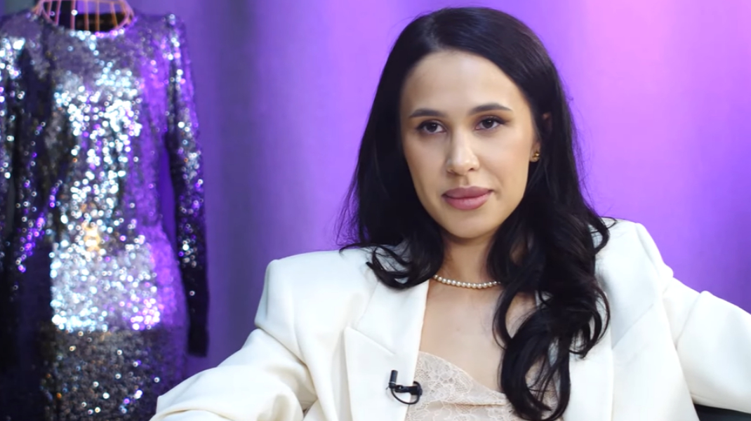 Alyssa Bounty in a white blazer and pearl necklace during her 2022 interview with Dorin Galben
